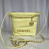 Chanel handbag with gold chain strap on a light gray background