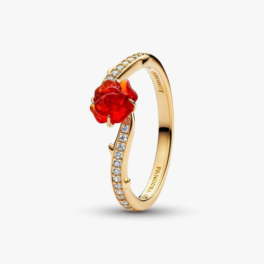 Gold ring with a red gemstone and small diamonds on a white background