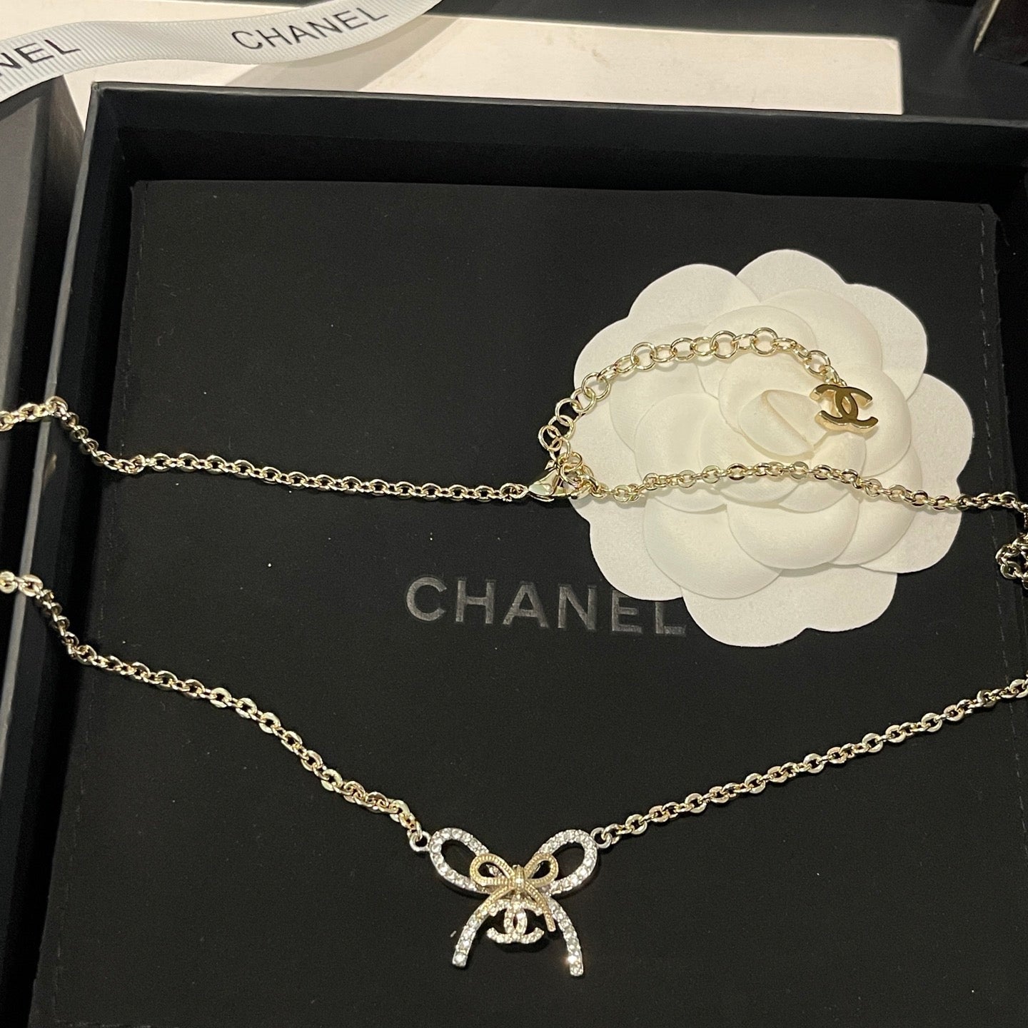 Chanel necklace with bow detail on a Chanel box