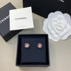 Chanel earrings in a box with Chanel branding in the background